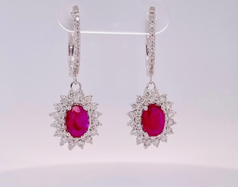 14 Karat White Gold Double Halo Dangle Earrings With 2=1.59CT Oval Ruby Gemstones And 0.94CT Round Diamonds