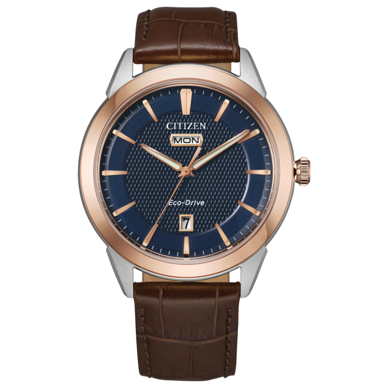 GENTS CITIZEN ECO DRIVE ROLAN WATCH TWO TONE ROSE GOLD TONE STAINLESS STEEL CASE AND BEZEL WITH DARK BLUE FACE AND BROWN LEATHER STRAP