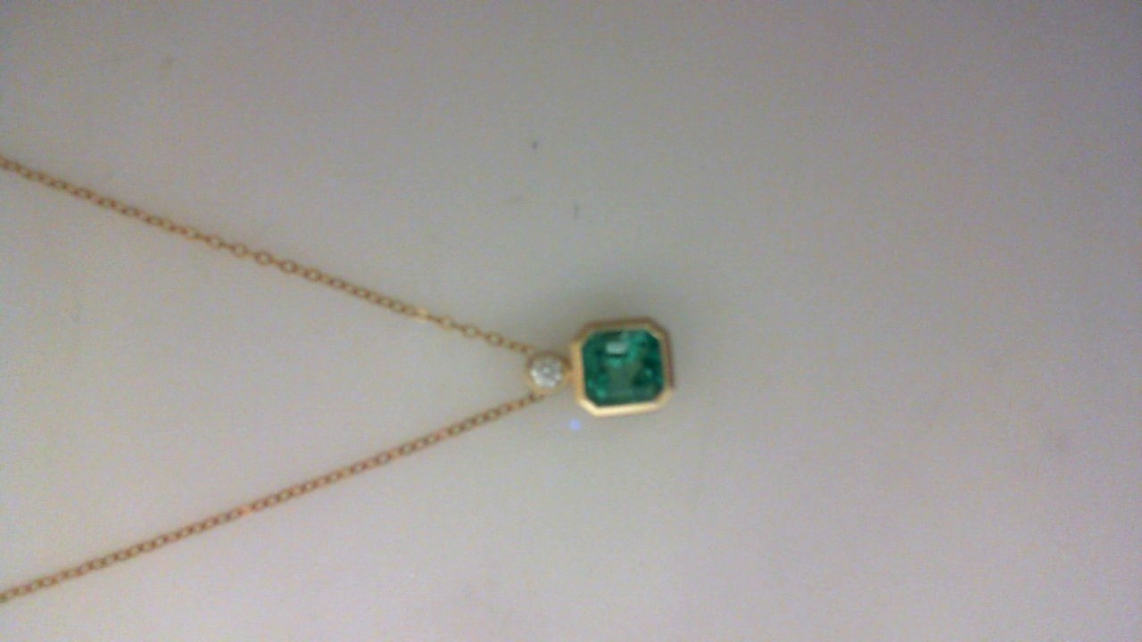 14K YELLOW GOLD 1.17CT EMERALD CUT EMERALD AND .06CT ROUND VS CLARITY & G COLOR DIAMOND BEZEL SET PENDANT ON A 16/17/18