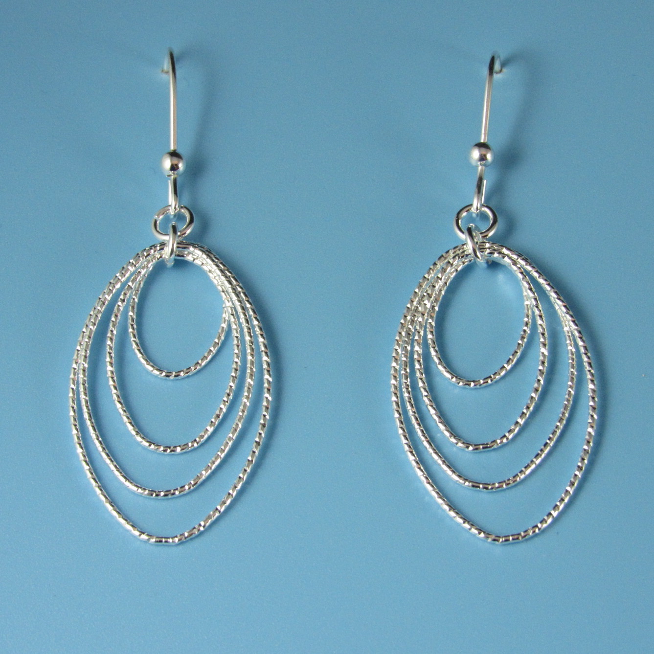 Sterling Silver Graduated Diamond Cut Oval Drop Earrings By Pd Collection